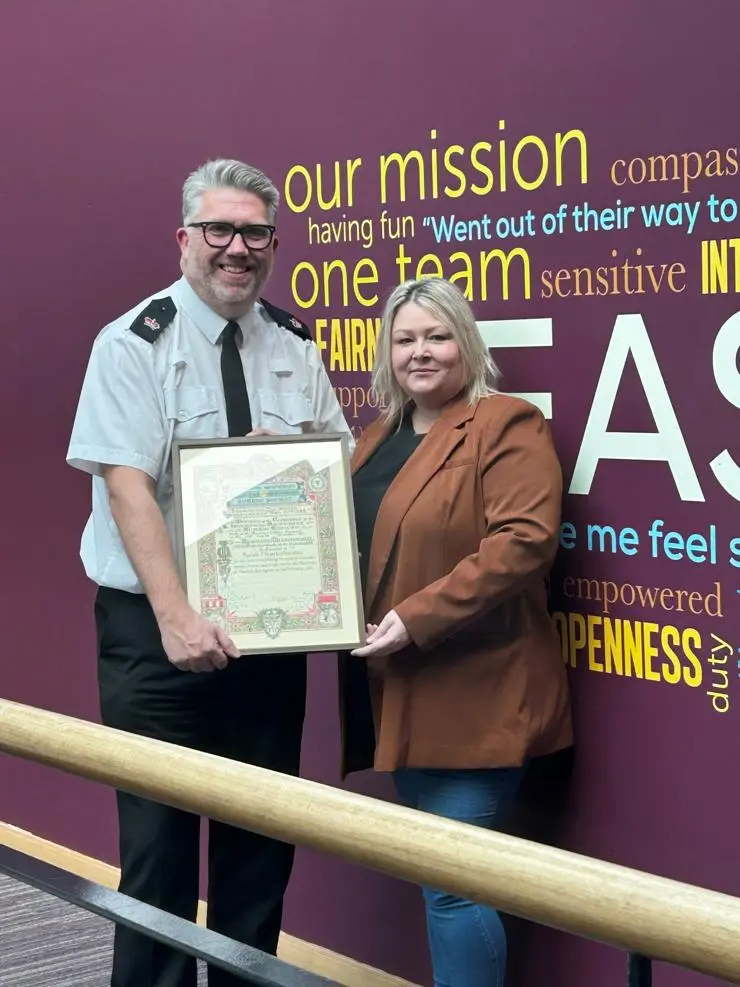 UCLan midwifery student is presented with her Liverpool Shipwreck and Humane Society Award parchment for bravery from Lancashire Police’s East Division Headquarters Operations Manager Superintendent Derry Crorken.